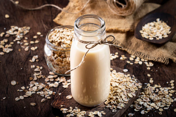 istock Oat flakes milk, non dairy alternative plant based drink in glass, wooden rustic kitchen table, copy space 1208822521