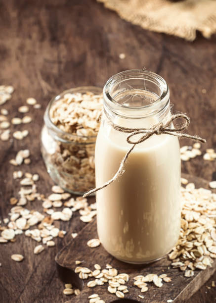 istock Oat flakes milk, non dairy alternative plant based drink in glass, wooden rustic kitchen table, copy space 1208822546
