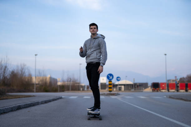 istock Man on a electric skateboard on an empty road 1208822785