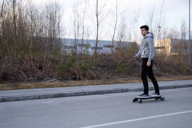 istock Man on a electric skateboard on an empty road 1208822890