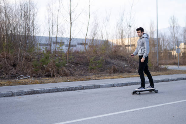 istock Man on a electric skateboard on an empty road 1208822908