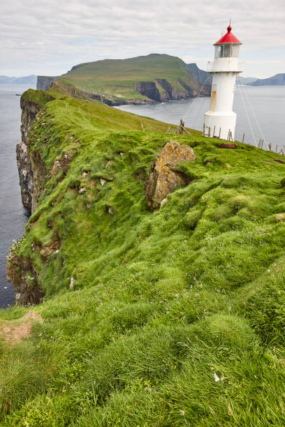 istock Mykines lighthouse and cliffs on Faroe islands. Hiking landmark 1208823075