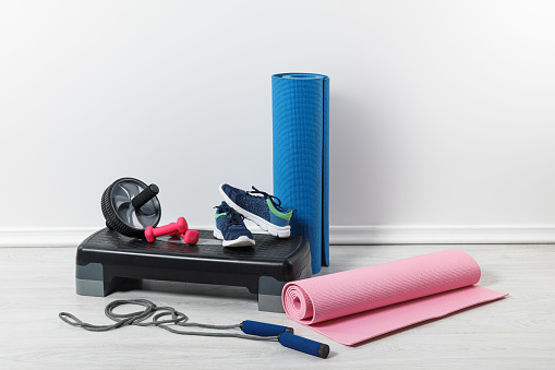 fitness mats and sports stuff on floor at home