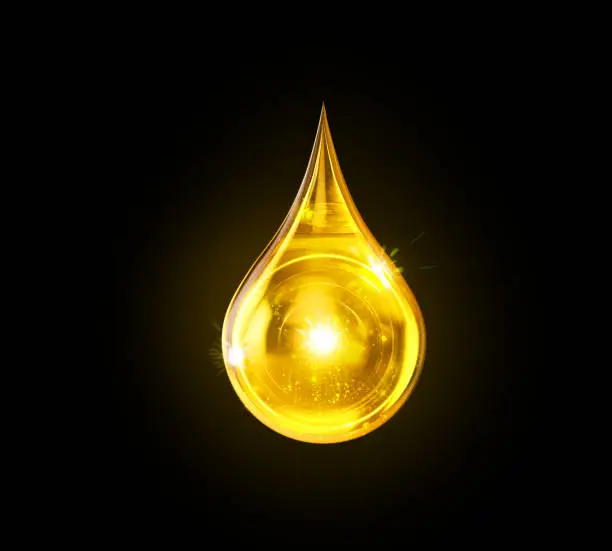 Photo of Oil drop isolated on black background.