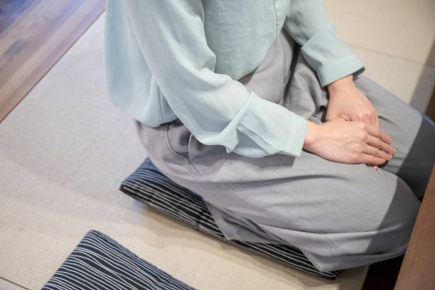 A woman resting in a Japanese-style room A woman resting in a Japanese-style room zabuton stock pictures, royalty-free photos & images