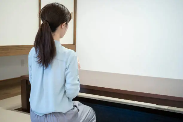 Back view of a young woman relaxing in a Japanese-style room