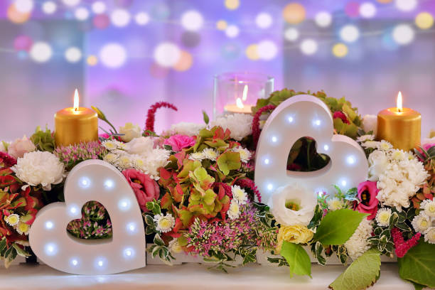 istock Wedding decoration two hearts in flowers and candles with empty space for text 1208826571
