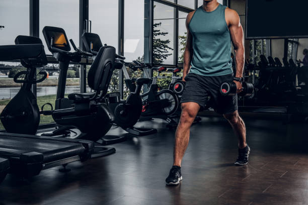 istock Man has training with dumbbells at gym 1208828451