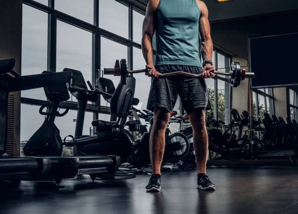 istock Man has training with dumbbells at gym 1208828469