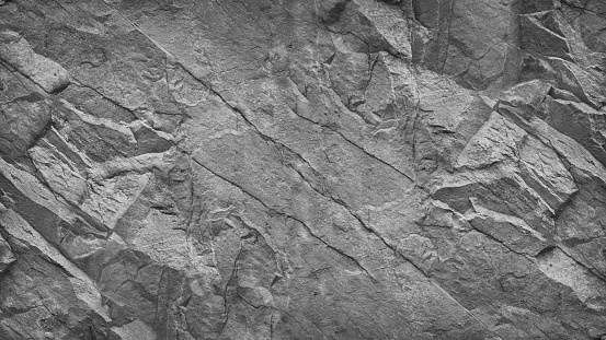 Rock texture closeup. Light gray stone background for your design.