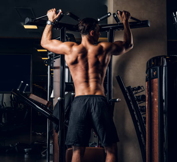 istock Muscular man is doing exercises with training apparatus 1208829165