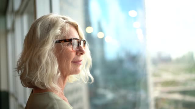 Mature businesswoman looking out of window