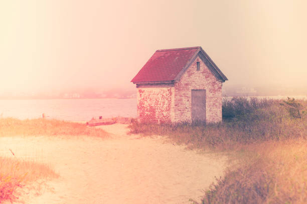 istock Vintage style rustic brick shed with red rood on seashore 1208830238