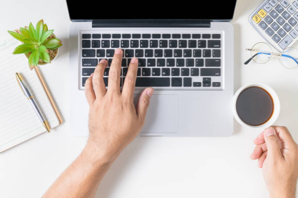 istock Business man typing laptop computer and holding hot coffee 1208830670