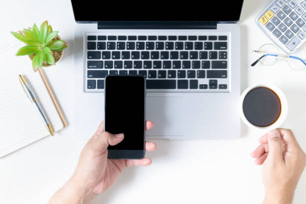 istock Business man holding smart phone and hot coffee 1208831017