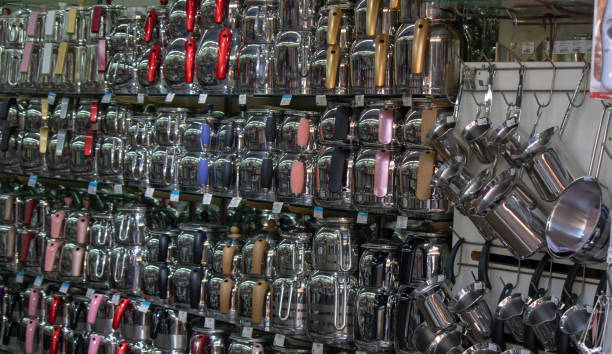 istock Steel teapots lined up on shelves. Available in different sizes and colors. 1208832078