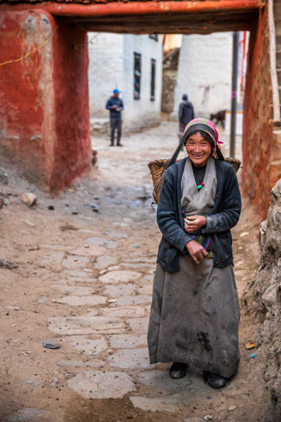 istock Tibetan woman carrying basket, Upper Mustang, Nepal 1208832149