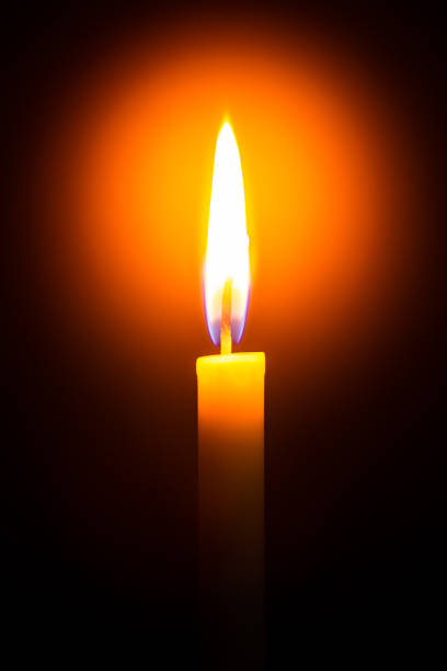 istock One light candle burning brightly in the black background 1208832434