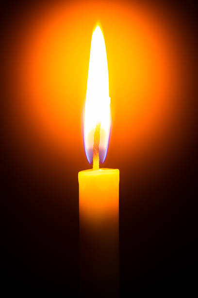 istock One light candle burning brightly in the black background 1208833826