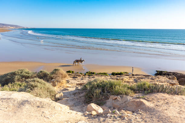 The Sea at Taghazout, Morocco Atlantic Ocean at Taghazout, a tourist area in Morocco that is receiving considerable investment in new hotels, apartments etc. sunset agadir marocco stock pictures, royalty-free photos & images
