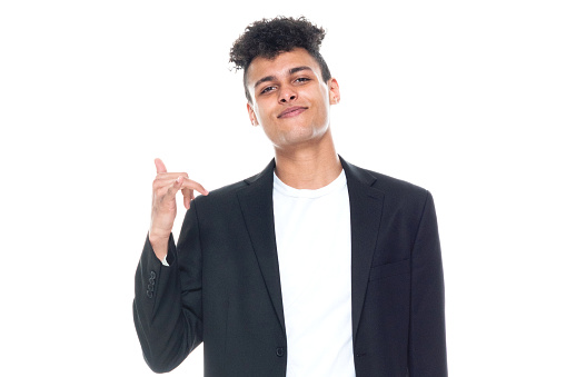 Front view of aged 20-29 years old who is tall person with curly hair african ethnicity male businessman in front of white background wearing business casual who is overworked who is show shaka sign ( hang loose )