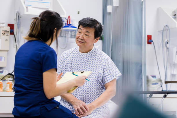 istock Emergency room nurse talks with patient 1208837426