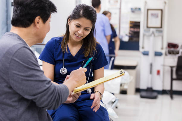 istock Mature man hands emergency room nurse check-in paperwork 1208837606