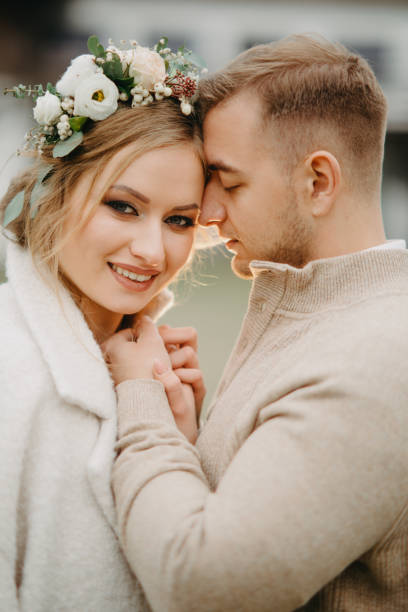 istock Newlyweds stand and embrace. 1208838298