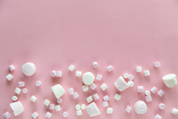 istock Background or texture of pink and white mini marshmallows on pink background with free space for text 1208838447