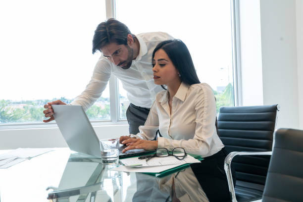istock Latin business colleagues working in office 1208839362