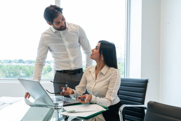 istock Latin business colleagues working in office 1208839364