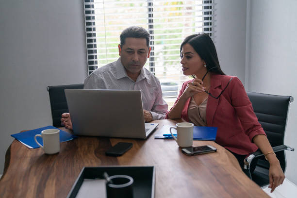 istock Latin business colleagues working in office. 1208839861