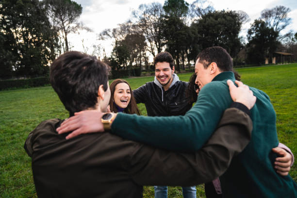 istock Multi ethnic group of friends embracing together, showing unity 1208839896