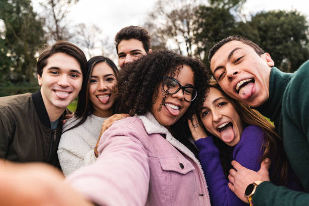 istock Multi ethnic group of six friends taking a selfie together while they are making faces 1208841095