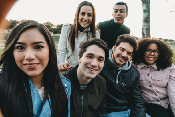 Pov view of six friends taking a selfie together outdoor Pov view of six friends taking a selfie together outdoor at sunset. Multi ethnic group. big family sunset stock pictures, royalty-free photos & images