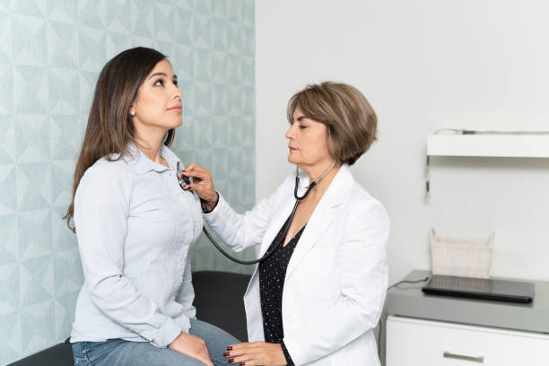 istock Doctor Examining Female Patient In Clinic 1208842586