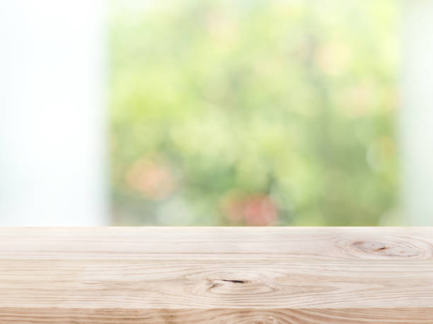 istock Empty wood table top on blur abstract green garden from window view in the morning 1208843501