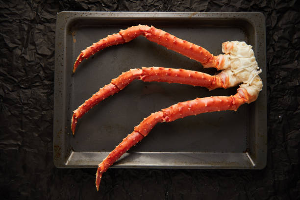 istock Image of fresh crab phalanges on oven-tray over dark background with copyspace 1208844577