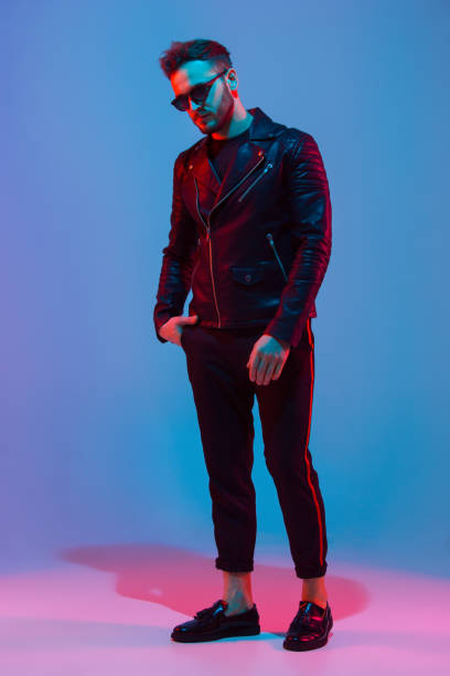 istock Caucasian man's portrait isolated on blue studio background in neon light 1208845898