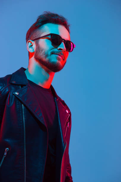 istock Caucasian man's portrait isolated on blue studio background in neon light 1208845925