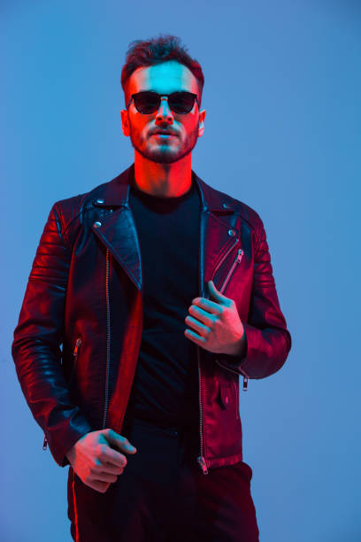 istock Caucasian man's portrait isolated on blue studio background in neon light 1208846330