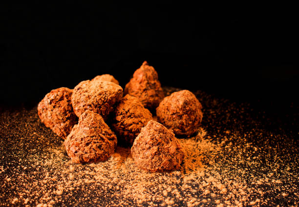 istock Chocolate truffle  with cocoa powder on a dark background 1208846401