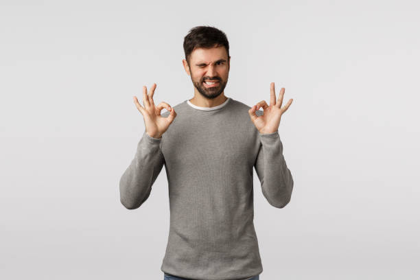 istock Relax all good. Assertive and skillful creative male coworker assure everything goes under plan, show okay, ok approval gesture and wink, smiling give assurance choice excellent, white background 1208846787