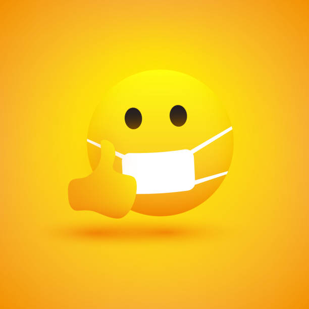 istock Serious Looking Emoticon Showing Thumbs Up and Wearing Medical Mask 1208847736