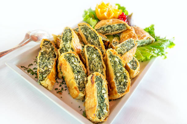 istock Tray with appetizer of salty spinach and ricotta cheese strudel 1208847784