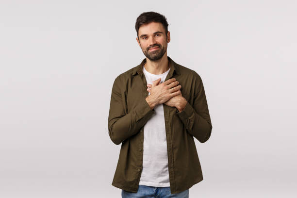 istock Kindness, happiness and friendship concept. Tender handsome man feeling touched and grateful for kind gift, touch heart and smiling delighted, express gratitude and delighted, thanking for help 1208848297