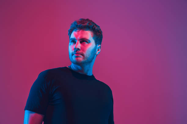 istock Young caucasian musician singing, dancing in neon light 1208849573