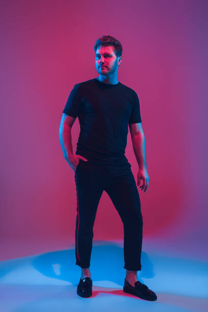 istock Young caucasian musician singing, dancing in neon light 1208849608