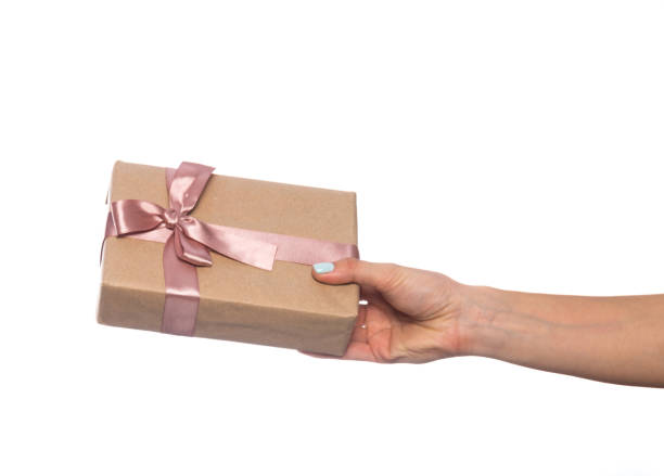 istock female hand holds a beautiful gift box with a bow isolated on white background 1208853048