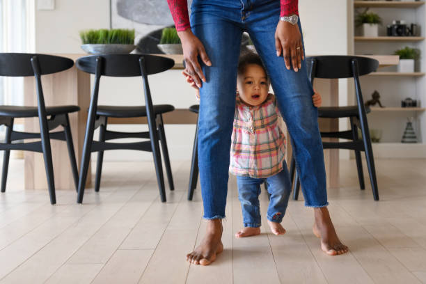 istock Baby girl first steps 1208853334